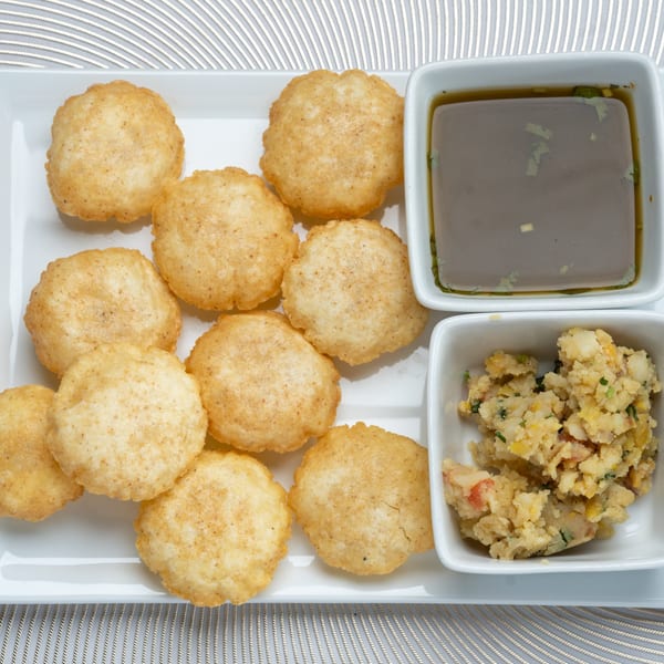 Pani Puri, an Indian street food, with crispy puri shells, spiced potato filling, and tangy pani.