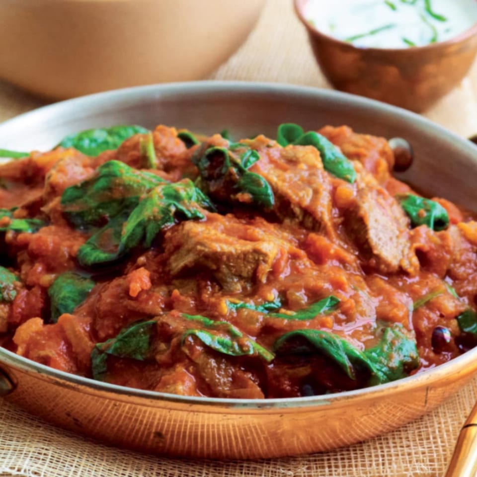 Taj Mahal Grill & Bar's Indian lamb curry with spinach in a copper pan.