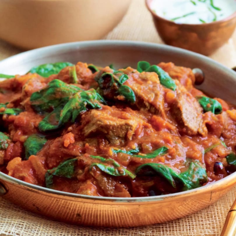 Taj Mahal Grill & Bar's Indian lamb curry with spinach in a copper pan.